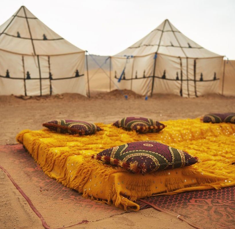 bed near the tents in desert