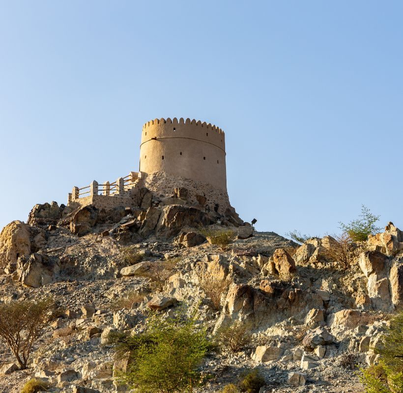 a stone tower on a rocky hill