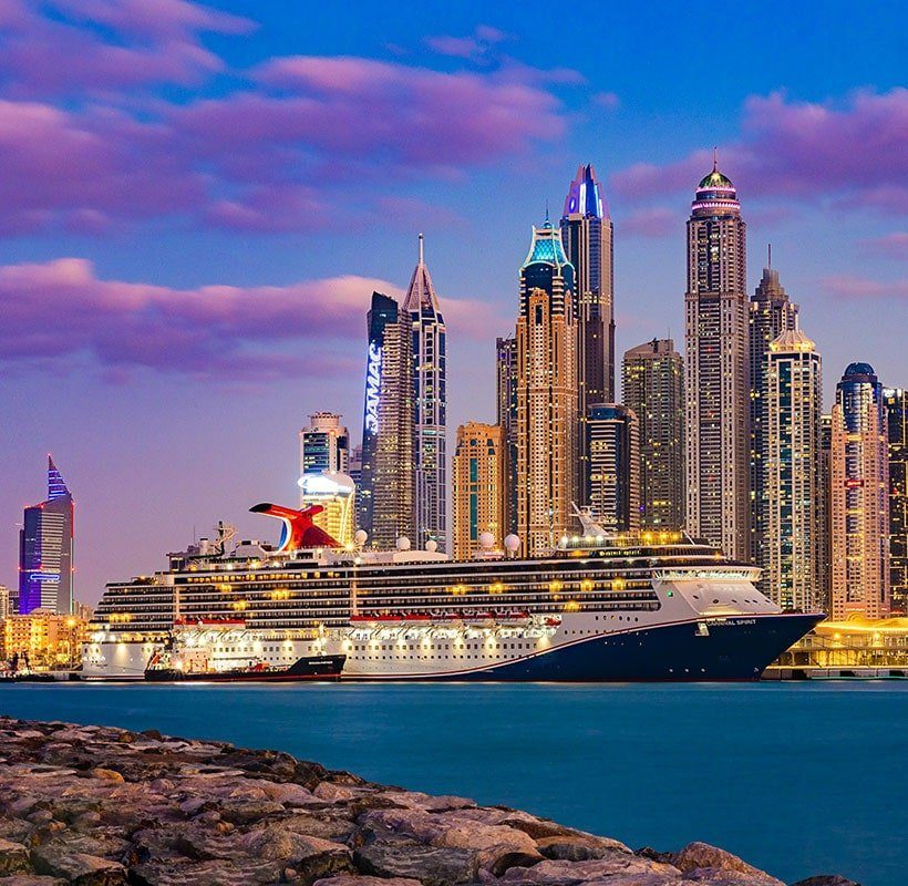 A Cruise is moving on the water near Dubai Buildings